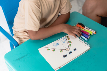 Fototapeta premium Child drawing colorful picture promoting imagination and creativity