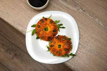 Homemade bagels with cream cheese, fish, cucumber and arugula in a plate with cup of coffee. Fresh breakfast. Top view.