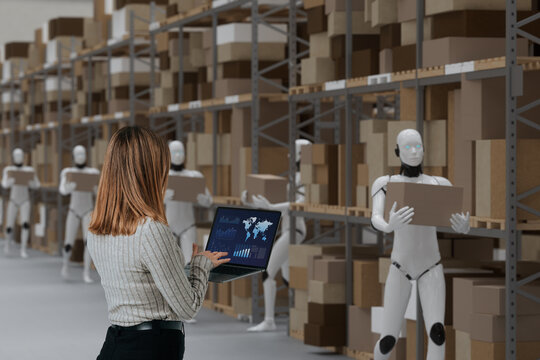 Supply chain manager monitoring warehouse robots handling inventory operations