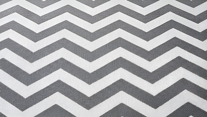Grey and white chevron pattern on fabric background