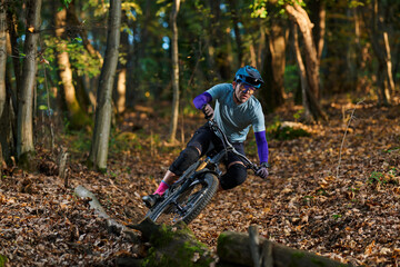 Intense Mountain Biking Through Autumn Forest Trail With Rider In Gear © .shock