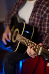 Obraz premium Close-Up of Guitarist Playing Acoustic Guitar