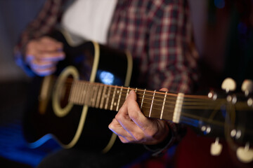 Obraz premium Close-Up of Guitarist Playing Acoustic Guitar