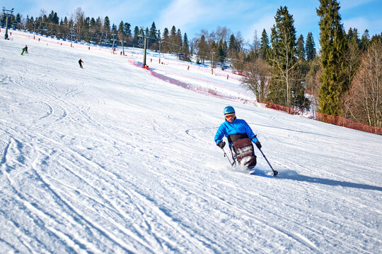 Adaptive winter sports for people with disabilities - a man skiing down a mountain