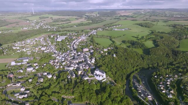 Wide panoramic aerial view of Wolkenstein in Saxony. The image shows the prominent location of the town and its castle on a mountain spur above the Zschopau Valley, surrounded by the hilly.