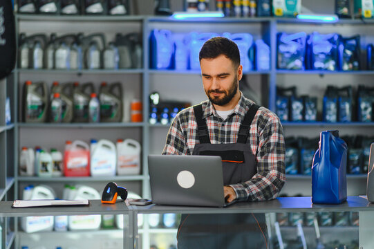 Auto parts store worker using laptop for inventory