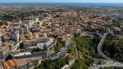 Obraz premium Aerial panoramic view of the historic center of Catanzaro, Italy. This city is the capital of the Calabria region. On the horizon, the Ionian Sea and a clear sky. It is a sunny summer morning.