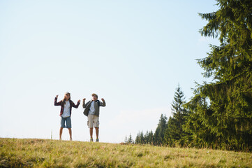 Young scouts jumping in the forest during summer vacation