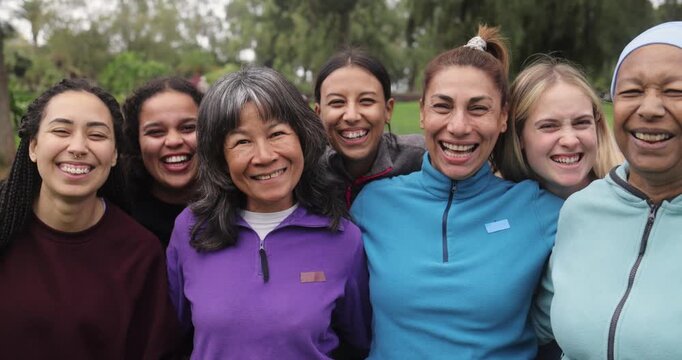 Group of happy multi generational women having fun together at city park - Multiracial friends laughing on camera after yoga class outdoor - Sport, diversity and women day concept
