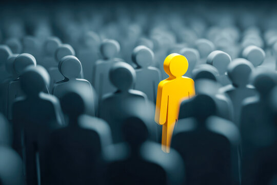Yellow figure standing out in a sea of dark gray silhouettes representing individuality, leadership, and uniqueness in a crowded environment