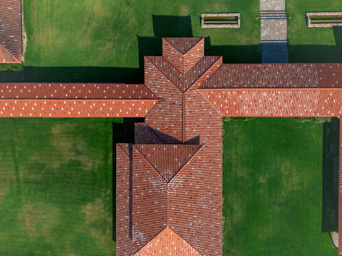 Aerial view of the architectural precision where terracotta roofs meet vibrant green lawns, creating a striking geometric pattern, Lujan de Cuyo, Mendoza Province, Argentina.
