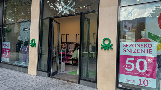 Upscale United Colors of Benetton fashion boutique entrance with vibrant signage offers whimsical seasonal discounts, echoing the spirit of sales; September 5, 2025, Saraevo, Bosnia i Herzegovina