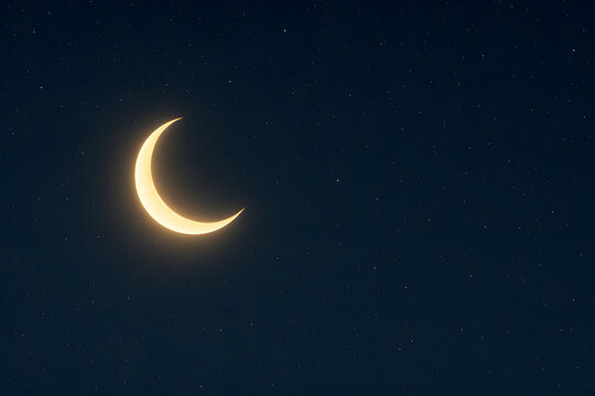 A serene night sky with a crescent moon shining brightly among the stars
