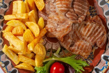 Chicken steak with potatoes and salad