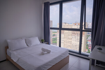 Fototapeta premium Minimal Budget Airbnb Bedroom with City View and Natural Light