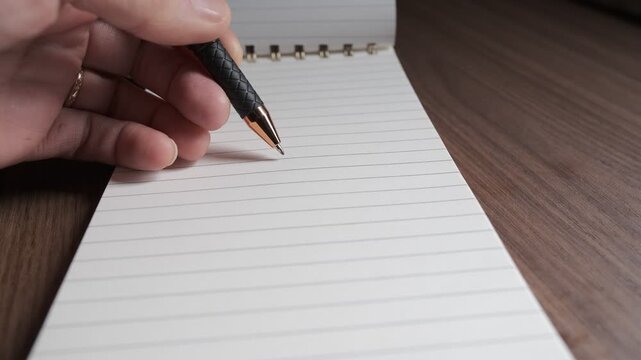 Hand with pen counting the lines of a diary