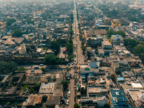 Aerial view of a bustling Jaipur cityscape, where historic architecture meets modern life under the warm Indian sun, creating a vibrant tapestry of urban existence, Jaipur, Rajasthan, India.