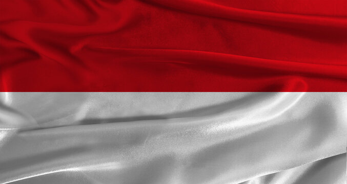 Flag of Monaco with fabric textured background. Close up of National flag of Monaco with realistic texture