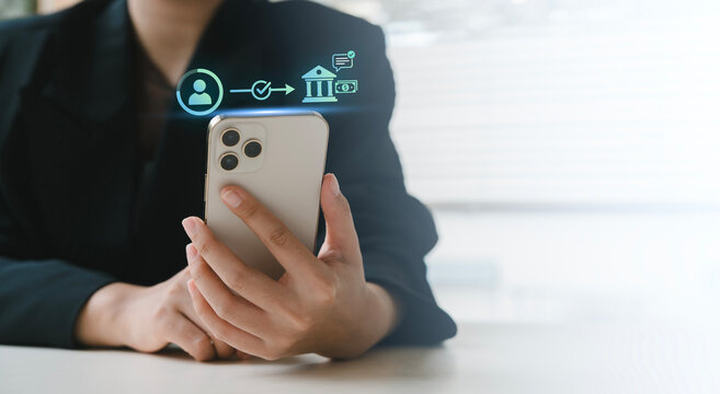 Online banking, Money transfer, Direct deposit, Mobile payment, Businesswoman holding smartphone with virtual simple user to bank money transfer transaction icons and notification alert, Transaction