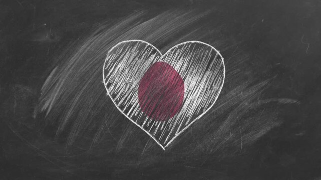The national flag of Japan in the shape of a heart, drawn with colored chalk on a blackboard. Japanese language, learning Japanese.