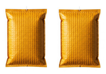 Two gold packets with shiny surface isolated on transparent background
