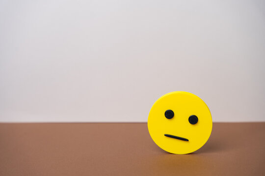Yellow neutral faced emoji representing dissatisfaction, indifference, or poor customer experience. Symbolizes bad mood, unimpressed reactions, or neutral feedback.