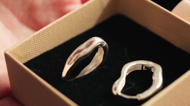 Silver earrings in a gift box. Handcrafted jewelry concept.