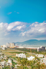 Obraz premium View from Marble Mountain in Vietnam of city with buildings, distant sea and mountains