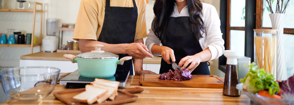 Love, food and cooking with couple in kitchen and hugging for breakfast, morning and happiness. Smile, care and nutrition with man and woman eating at home for happy