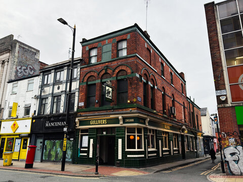 Manchester city Oldham street pub Gullivers on a brick corner building with green tiles