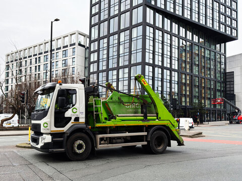 Tow Circle truck on urban street in Manchester with modern office buildings in the background