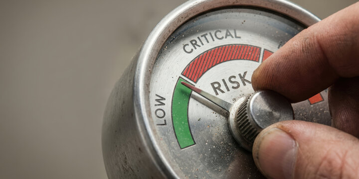Risk control dial with hand adjusting to low critical level showing ai risk controls concept