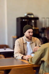 Fototapeta premium Casual Conversation At A Coffee Shop Between Friends During A Relaxed Meeting