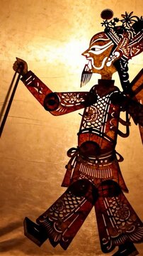 Vertical video: Pulling control rods, cut puppet stepping forward on parchment screen for show