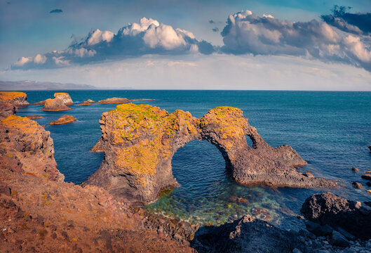Majestic summer view of popular tourist destination - Gatklettur, Arnarstapi or Stapi village location, Iceland, Europe. Wondeful morning seascape of Atlantic Ocean. 