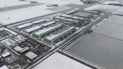 Aerial view snowing on data center buildings and greenhouses