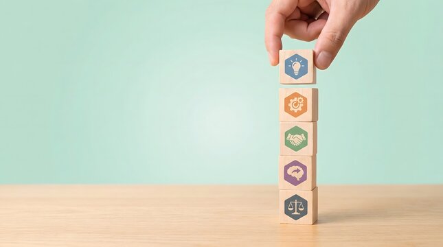 hand placing wooden block with icon on stack of blocks