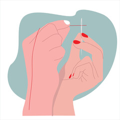 hand threading the needle.  human hands with a needle threading through the eye of a needle
