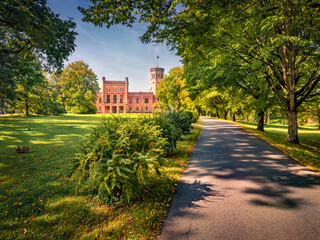 Fototapeta premium Adorable morning view of Vecauces castle with empty walkeway, Latvia, Europe. Impressive summer scene of Vecauce village. Traveling concept background.