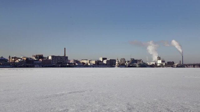 Frozen Dnieper River Surface With Podil City Embankment In Kyiv