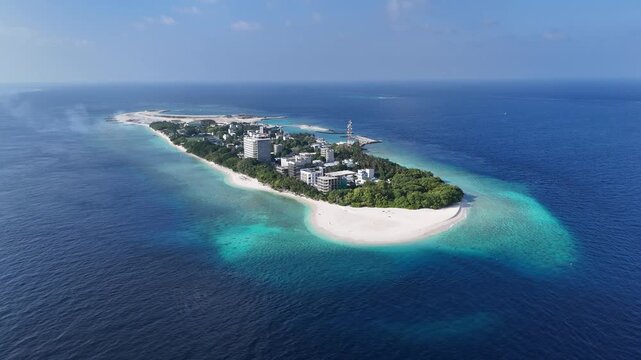 Aerial drone view of Ukulhas island Maldives surrounded by turquoise lagoon and deep blue ocean