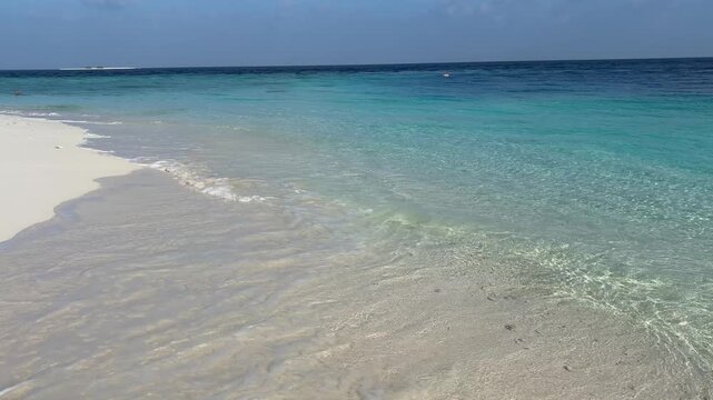 Ukulhas beach Maldives with white sand shoreline and calm turquoise ocean