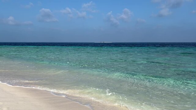 Ukulhas beach Maldives with white sand shoreline and calm turquoise ocean
