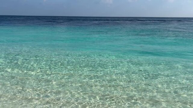 Ukulhas beach Maldives with white sand shoreline and calm turquoise ocean
