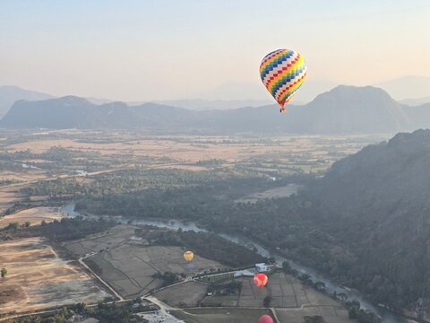 Hot Air Balloon Floats over the Mountain Valley &ndash; Zoomed In