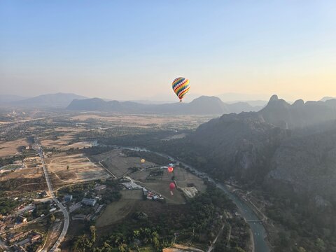 Hot Air Balloon Floats over the Mountain Valley