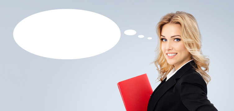 Portrait image of emotional smiling businesswoman business woman wear corporate suit jacket with red folder, isolated grey gray background. White empty mockup speech bubble. Free ad text space