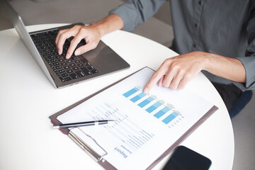 Closeup hand of businessman, accountant, banker at the workplace typing on laptop