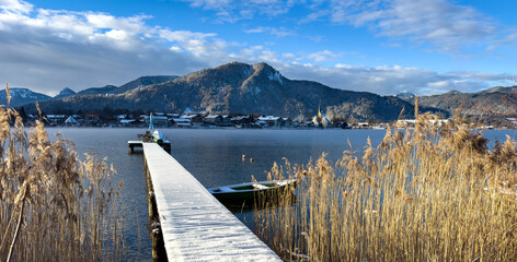 Panorama lake in the Bavaria mountains on the tegernsee with wooden pier winter landscape