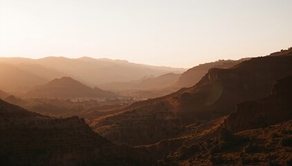 Naklejka premium Sunrise Over Rolling Hills and Valleys in a Mountainous Region During Early Morning Hours